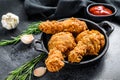 Spicy Deep Fried Breaded Chicken drumsticks. Black background. Top view