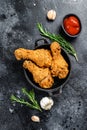 Spicy Deep Fried Breaded Chicken drumsticks. Black background. Top view