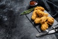 Spicy Deep Fried Breaded Chicken Wings. Black background. Top view. Copy space Royalty Free Stock Photo