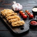 Spicy deep fried breaded chicken wings on dark wooden background Royalty Free Stock Photo