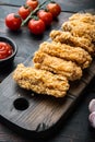 Spicy deep fried breaded chicken wings on old dark wooden table Royalty Free Stock Photo