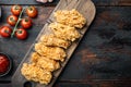 Spicy deep fried breaded chicken wings on old dark wooden table, top view, with copy space Royalty Free Stock Photo