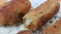 Spicy and delicious croquettes served in ceramic plate over wooden floor