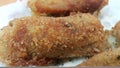 Spicy and delicious croquettes served in ceramic plate over wooden floor