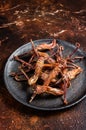 Spicy Dip fried duck tongue. Dark background. Top view Royalty Free Stock Photo