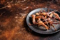 Spicy Dip fried duck tongue. Dark background. Top view. Copy space Royalty Free Stock Photo