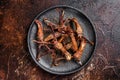 Spicy Dip fried duck tongue. Dark background. Top view Royalty Free Stock Photo