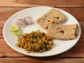 Spicy Egg bhurji or anda bhurji with Chapati, Scrambled egg with Indian flat bread, Protein rich breakfast food. served over a