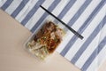 Spicy egg noodle with dumplings shrimp, roasted pork and marinated pork chop on wooden background. Royalty Free Stock Photo