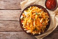 Spicy fast food: French fries with cheddar cheese, chili and chi Royalty Free Stock Photo