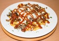 Spicy fast food: French fries with cheddar cheese, chili and chicken fillet, close-up sauce on a plate. Background Royalty Free Stock Photo