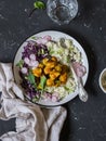 Spicy fish taco bowls. Delicious food. On a dark stone background.