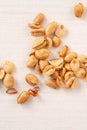 Spicy flavored peanut kernel spilling on white table background