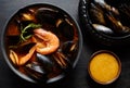 Spicy french soup bouillabaisse with seafood, prawns, mussels. Traditional in France, Spain. Dark rustic style.