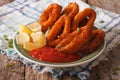 Spicy fried calamari rings with ketchup and lemon on a plate. ho Royalty Free Stock Photo