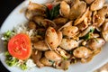 Spicy fried clams with basil in the dish Royalty Free Stock Photo