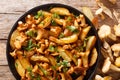 Spicy fried potato with forest mushrooms chanterelles close-up on a plate. horizontal top view Royalty Free Stock Photo