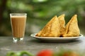 Indian street foods- spicy vegan samosa with tea,