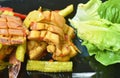 Spicy fried squid with chili and lemon leaf couple lettuce on plate