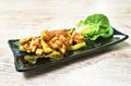 Spicy fried squid with chili and lemon leaf couple lettuce on plate
