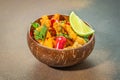 Spicy fried vegetables with chili, herbs, and lime served in a rustic coconut bowl Royalty Free Stock Photo