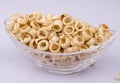 Spicy fryums or snacks, or corn rings in glass bowl