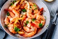 Spicy garlic chilli Shrimps on frying pan with lemon and cilantro Royalty Free Stock Photo