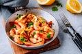 Spicy garlic chilli Shrimps on frying pan with lemon and cilantro Royalty Free Stock Photo