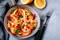 Spicy garlic chilli Shrimps on frying pan with lemon and cilantro Royalty Free Stock Photo