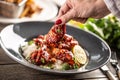 Spicy glazed chicken thighs and wings served with rice and coriander leaves