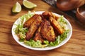 Spicy Grilled Chicken Wings with lemon and salad served in dish isolated on table side view of middle east food Royalty Free Stock Photo