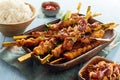 Spicy grilled satay skewers with fluffy white rice Royalty Free Stock Photo