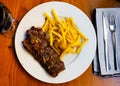 Spicy grilled veal tenderloin with French fries