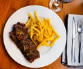 Spicy grilled veal tenderloin with French fries