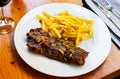 Spicy grilled veal tenderloin with French fries