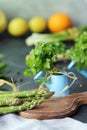 Spicy herbs, asparagus, lemons, seasonings, lentils on the kitchen table for preparing healthy homemade food