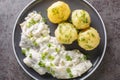 Spicy herring fillet in a creamy sauce with a garnish of boiled potatoes close-up in a plate. horizontal top view Royalty Free Stock Photo