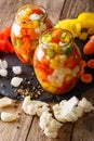 Spicy Homemade Pickled Giardiniera with Peppers, Carrots and Cauliflower close-up. Vertical