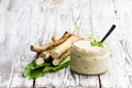 Spicy horseradish sauce in small glass jar on wooden table Royalty Free Stock Photo