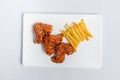 Spicy hot buffalo wings and french fries with white sauce Royalty Free Stock Photo