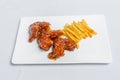 Spicy hot buffalo wings and french fries with white sauce Royalty Free Stock Photo