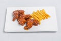 Spicy hot buffalo wings and french fries with white sauce Royalty Free Stock Photo