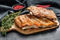 Spicy hot grilled pork spare ribs from BBQ served on cutting board. Black background. Top view Royalty Free Stock Photo