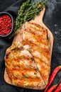 Spicy hot grilled pork spare ribs from BBQ served on cutting board. Black background. Top view Royalty Free Stock Photo