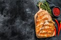 Spicy hot grilled pork spare ribs from BBQ served on cutting board. Black background. Top view. Copy space Royalty Free Stock Photo