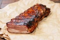 Spicy hot grilled spare ribs from a summer BBQ. paper craft background. Royalty Free Stock Photo