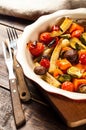 Spicy hot vegetables, cooked on an grill in ceramic bowl on wooden background. The concept of healthy eating and delicious food Royalty Free Stock Photo