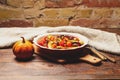 Spicy hot vegetables, cooked on an grill in ceramic bowl on wooden background. The concept of healthy eating and delicious food. Royalty Free Stock Photo