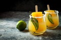 Spicy mango popsicle margarita cocktail with jalapeno and lime. Mexican alcoholic drink for Cinco de mayo party.