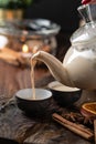 Spicy milk Indian tea Masala poured into a glass from a teapot. Aromatic hot drink Royalty Free Stock Photo